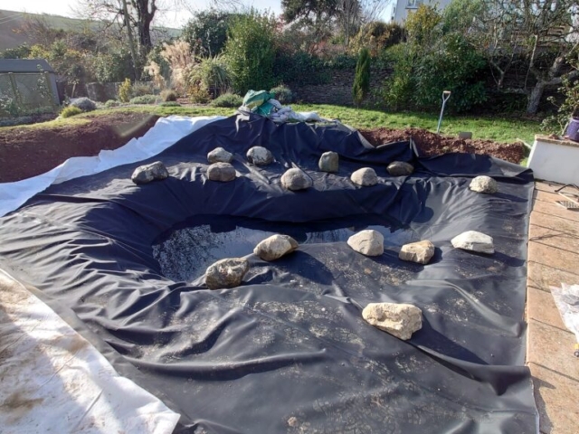 Liner Positioned, Stone & Boulders Being Placed Pond Building Devon